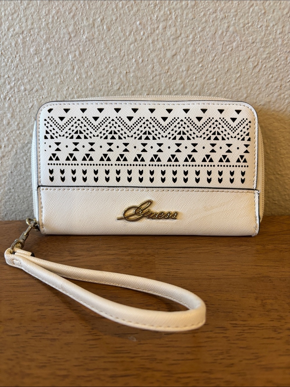 Guess White Wristlet Clutch with Geometric Cutout Design and phone carry.